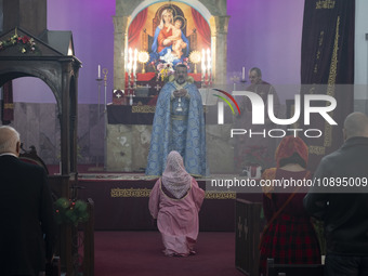 Iranian-Armenian clergymen and a clergywoman are praying at the St. Vartan Armenian Church in central Tehran, participating in a Christmas m...