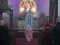 Iranian-Armenian clergymen and a clergywoman are praying at the St. Vartan Armenian Church in central Tehran, participating in a Christmas m...