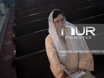 An Iranian-Armenian clergywoman is sitting at the St. Vartan Armenian Church in central Tehran, participating in a Christmas mass prayer cer...