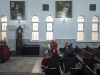 An Iranian-Armenian family is praying at the St. Vartan Armenian Church in central Tehran during a Christmas mass prayer ceremony on January...