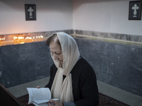 An Iranian-Armenian woman is praying at the St. Vartan Armenian Church in central Tehran during a Christmas mass prayer ceremony on January...