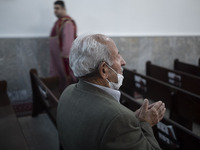 An Iranian-Armenian man is praying at the St. Vartan Armenian Church in central Tehran during a Christmas mass prayer ceremony on January 6,...