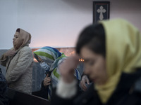 Iranian-Armenian women are praying at the St. Vartan Armenian Church in central Tehran during a Christmas mass prayer ceremony on January 6,...