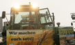 Hundreds of tractors, trucks, and cars are parked as farmers from nearby communities begin...