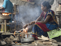 A woman is making Assamese traditional Tel Pitha or Ghila Pitha ahead of the Magh Bihu, also known as Bhogali Bihu festival, in Guwahati, As...