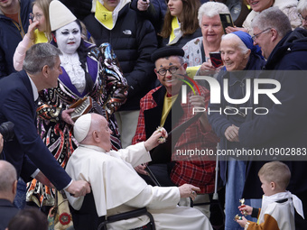 Pope Francis is posing with participants during his weekly general audience in the Paul VI Audience Hall in Vatican City, on January 10, 202...