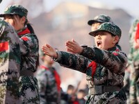 Children are demonstrating military boxing during a national defense education class at Bengbu Road No. 3 Primary School in Hefei, East Chin...