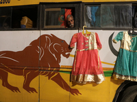 A Hindu devotee is sitting on a passenger bus, getting ready to travel from a transit camp on their way to Ganganagar, a Hindu pilgrimage si...