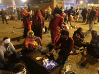 A devotee is arranging food at a transit camp on their way to Ganganagar, a Hindu pilgrimage site that devotees visit for an annual holy dip...