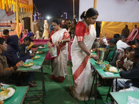 Indian transgender individuals are distributing free food to Hindu pilgrims at a camp organized by a social organization run by the transgen...