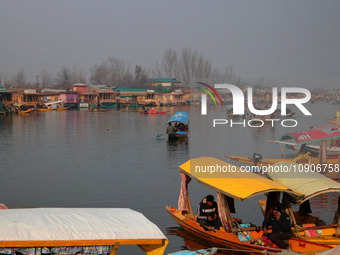 Tourists are enjoying boat rides at Dal Lake in Srinagar, Kashmir, India, on January 12, 2024. Special congregational prayers called ''Salat...