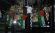 Palestinian flags hang on a security fence during a demonstration outside of the White Hou...