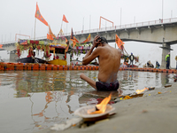 A man is bathing near the Saryu River ghat ahead of the Ram temple opening in Ayodhya, Uttar Pradesh, India, on January 20, 2024. (