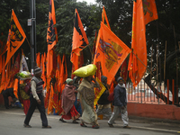 Devotees are walking past Lord Ram and Sita devotional flags in a roadside shop ahead of the Ram temple opening in Ayodhya, Uttar Pradesh, I...