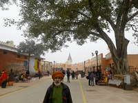 People are walking past the temple area ahead of the Ram temple opening in Ayodhya, Uttar Pradesh, India, on January 20, 2024. (