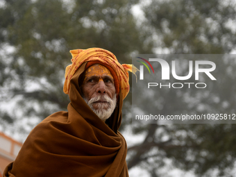 An old man is posing for a portrait near a temple area before the opening of the Ram temple in Ayodhya, Uttar Pradesh, India, on January 20,...