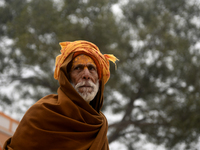 An old man is posing for a portrait near a temple area before the opening of the Ram temple in Ayodhya, Uttar Pradesh, India, on January 20,...