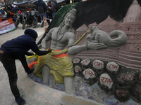 A man is making a sand painting of Lord Ram and the Ram temple ahead of its opening in Ayodhya, Uttar Pradesh, India, on January 20, 2024. (