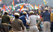 Security personnel are attempting to stop Congress workers from crossing police barricades...