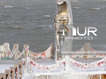 The statue of the Old Man of the Moon is being covered with snow and ice in Yantai, Shandong Province, China, on January 22, 2024. (