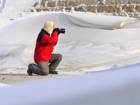 A tourist is taking photos of the snow landscape in Yantai, China, on January 22, 2024. (