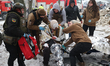 First responders are giving first aid to an injured person following a Russian missile att...