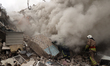 A firefighter is walking on the rubble after the Russian missile attack in Kharkiv, Ukrain...