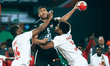 Yehia Khaled is in action with an Angola player during the 26th edition of the African Men...