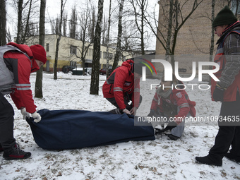 Volunteers from a rapid response unit of the Ukrainian Red Cross Society are setting up a tent to provide help for people being evacuated fr...