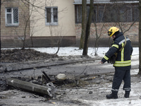 A rescuer is pointing to the ground in the Sviatoshynskyi district after the Russian missile attack on Tuesday morning, in Kyiv, Ukraine, on...