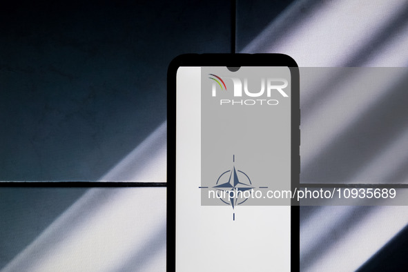 The NATO logo is displayed on a smartphone screen in Athens, Greece, on January 24, 2024. 