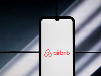The Airbnb logo is displayed on a smartphone screen in Athens, Greece, on January 24, 2024. (