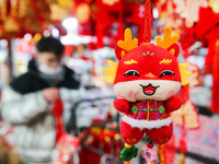 Customers are shopping for Spring Festival ornaments at a small commodity market in Lianyungang, China, on January 27, 2024. (
