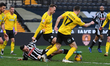 Macaulay Langstaff of Notts County is battling with George Ray and James Chester of Barrow...