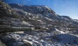 A panoramic view is showing the train as it travels through Hallingskarvet National Park o...