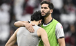 Mahmoud Wadi (R) of Palestine is comforting Mohammed Saleh after the AFC Asian Cup 2023 ro...