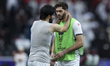 Mahmoud Wadi (R) of Palestine is comforting Mohammed Saleh after the AFC Asian Cup 2023 ro...