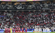 The teams of Qatar (L) and Palestine (R) are standing for a minute of silence as a symbol...