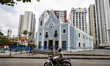 People are walking in front of the Church of Nossa Senhora da Boa Viagem (Our Lady of Good...
