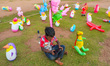A child is using a cellphone surrounded by toys in Colombo, Sri Lanka, on January 31, 2024...