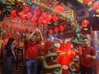 A person of Chinese descent is performing a prayer during the Chinese New Year Eve celebration at Hong San Ko Tee Temple in Surabaya, East J...