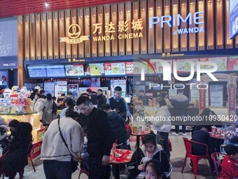 People are buying tickets to watch a movie at Wanda Cinema in Tengzhou, China, on February 10, 2024. (