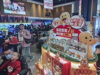 People are buying tickets to watch a movie at Wanda Cinema in Tengzhou, China, on February 10, 2024. (