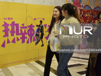Visitors are passing by movie posters at a cinema in Fuyang, China, on February 10, 2024. (