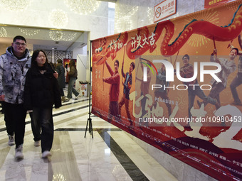 Visitors are passing by movie posters at a cinema in Fuyang, China, on February 10, 2024. (