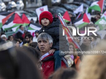 A man is carrying a child during a rally for Palestine in central Lisbon, Portugal, on February 10, 2024. The protest was organized by a gro...