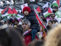 A man is carrying a child during a rally for Palestine in central Lisbon, Portugal, on February 10, 2024. The protest was organized by a gro...