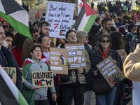 Activists are holding signs with pro-Palestinian inscriptions during a rally for Palestine in downtown Lisbon, Portugal, on February 10, 202...
