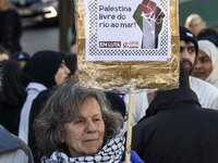 An activist is holding up posters with pro-Palestinian inscriptions during a rally for Palestine in downtown Lisbon, Portugal, on February 1...