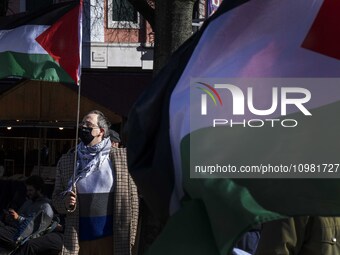 An activist is carrying a Palestinian flag during a rally in downtown Lisbon, Portugal, on February 10, 2024. The protest action is being or...